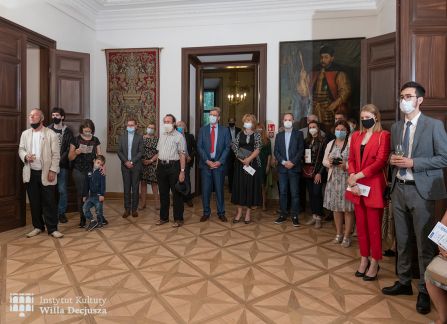 fotografia. otwarcie wystawy milana lukacsa w willi decjusza. goście wernisażu stoją w półkolu w sali balowej willi decjusza.